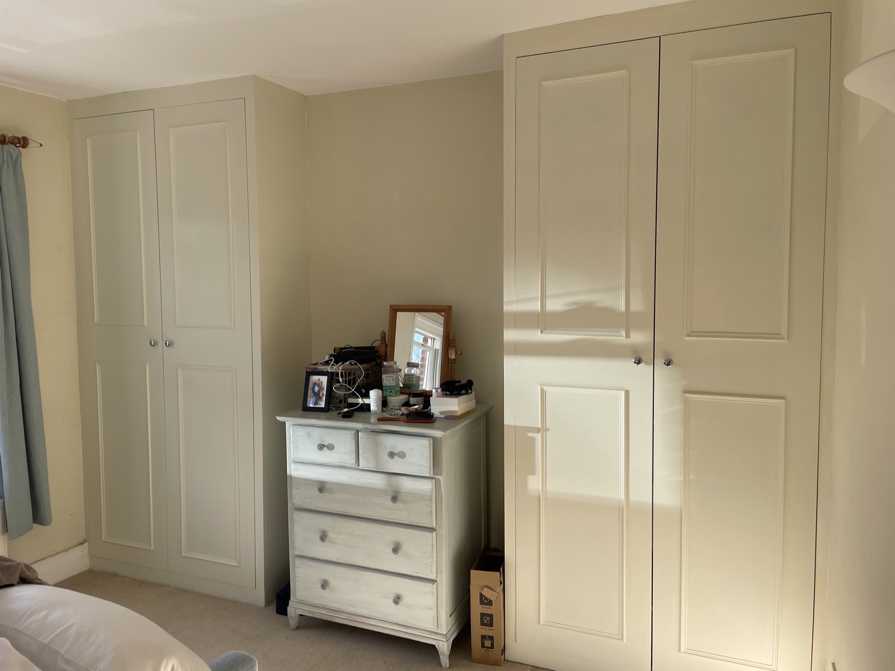 Pair of fitted alcove wardrobes flanking a chimney breast