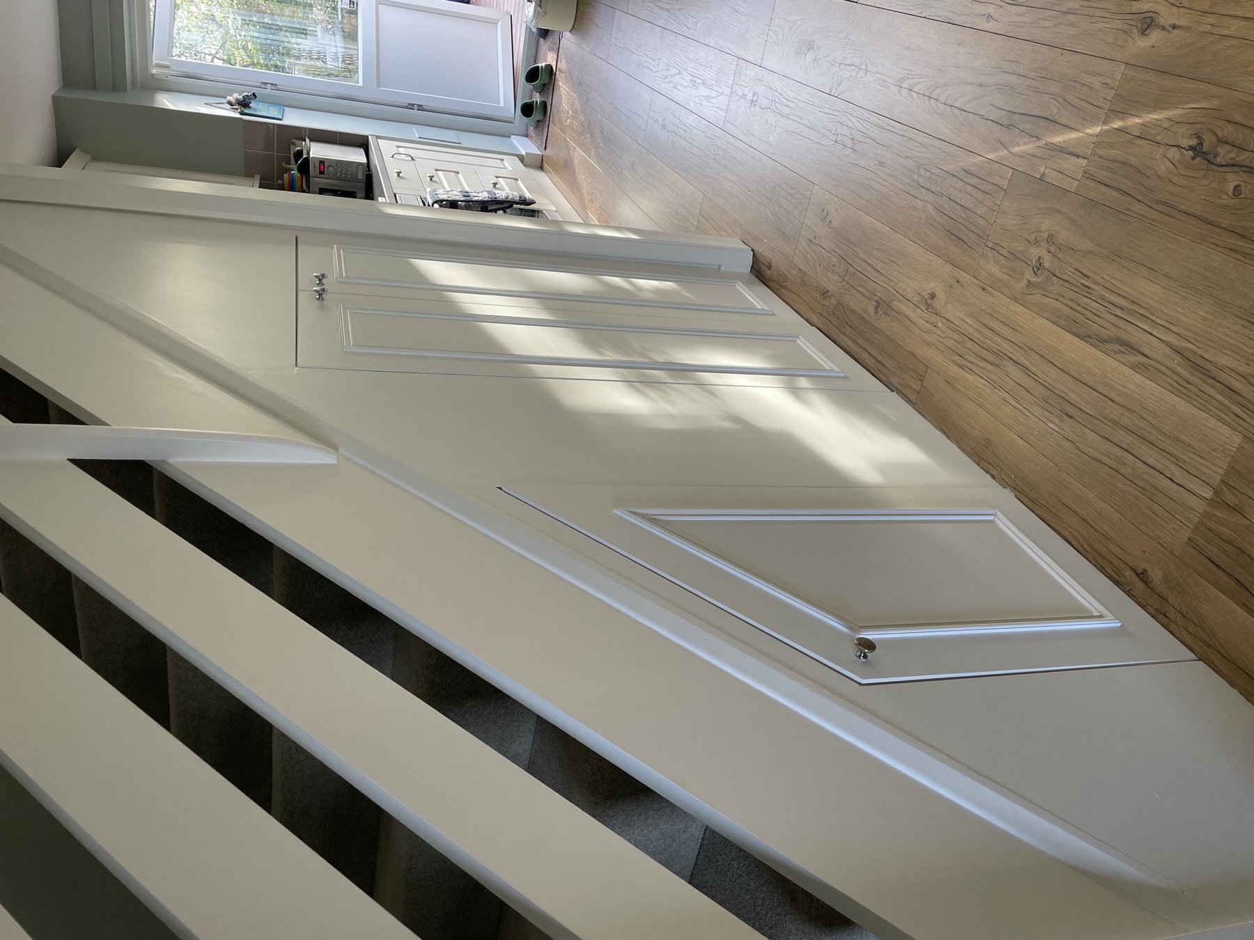 Angled understairs cupboards following the stair line