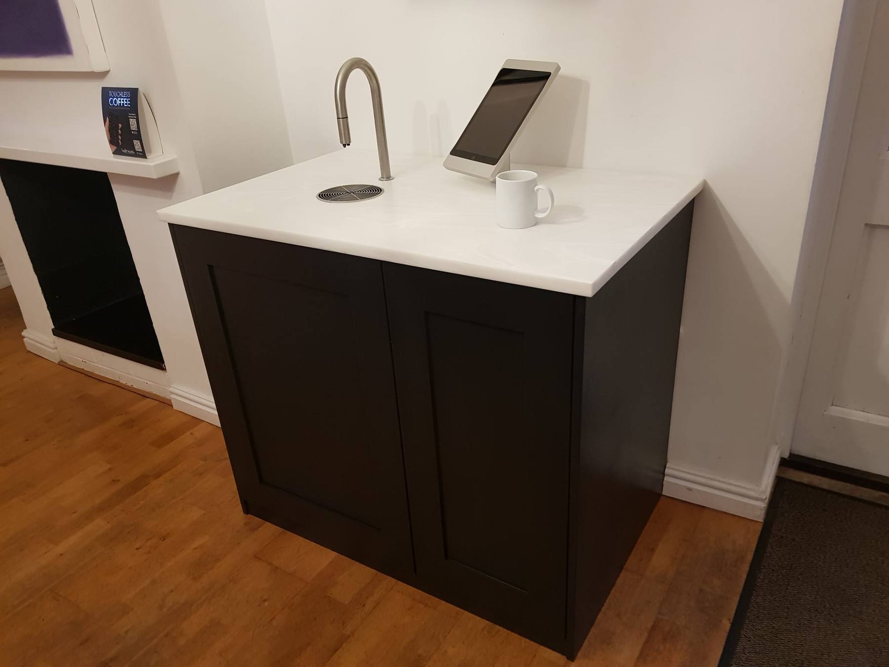 Bespoke cabinet with a stone worktop housing a built-in coffee machine