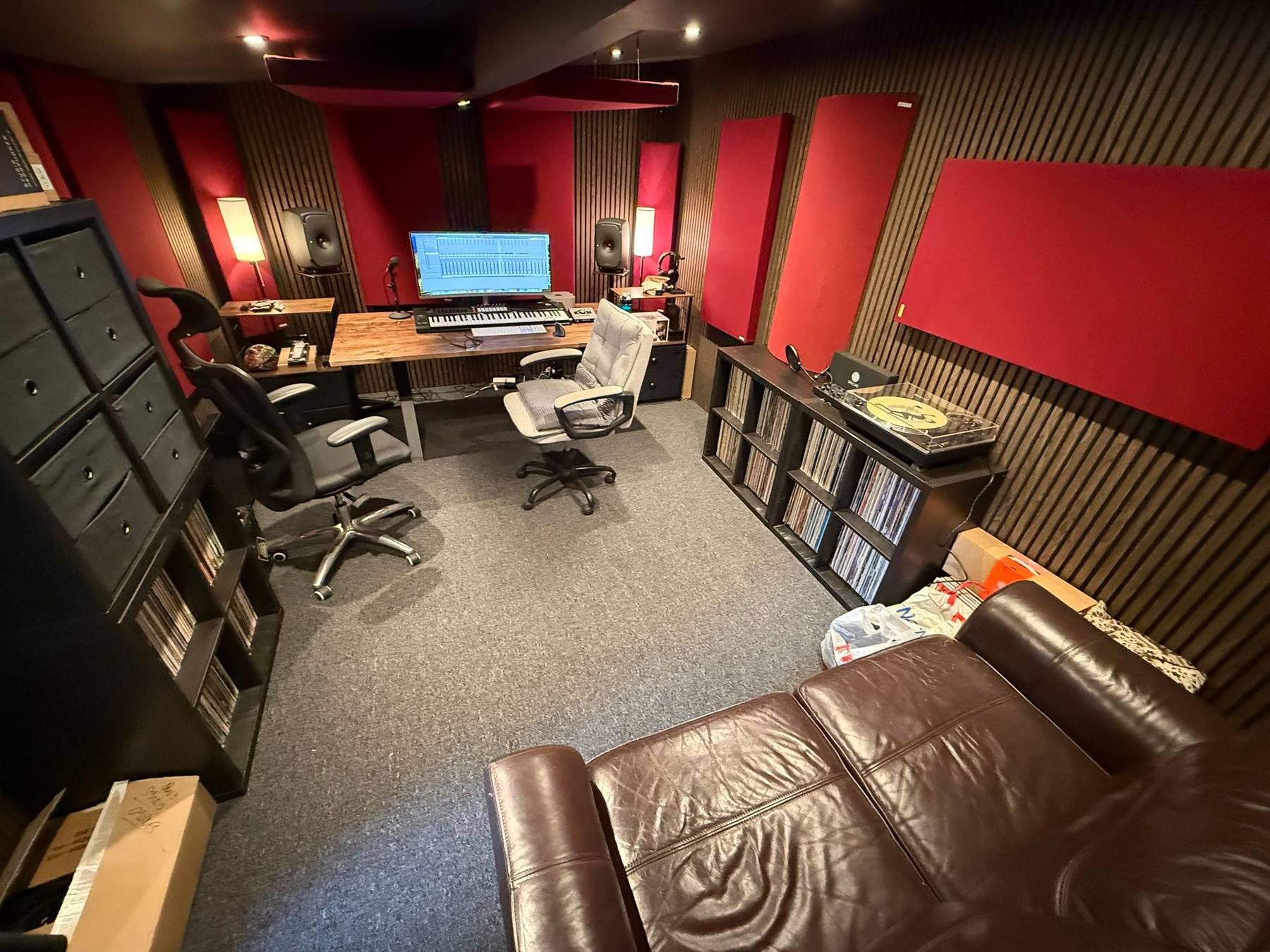 Garage converted into a music studio with slatted acoustic panelling and a fitted workstation