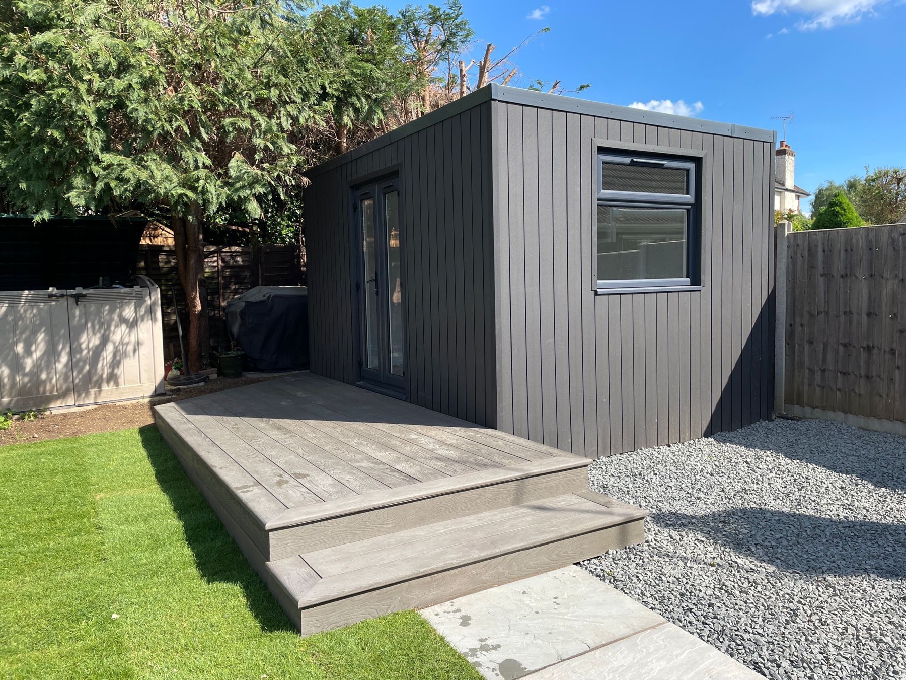 Millboard composite deck and step up to a garden building